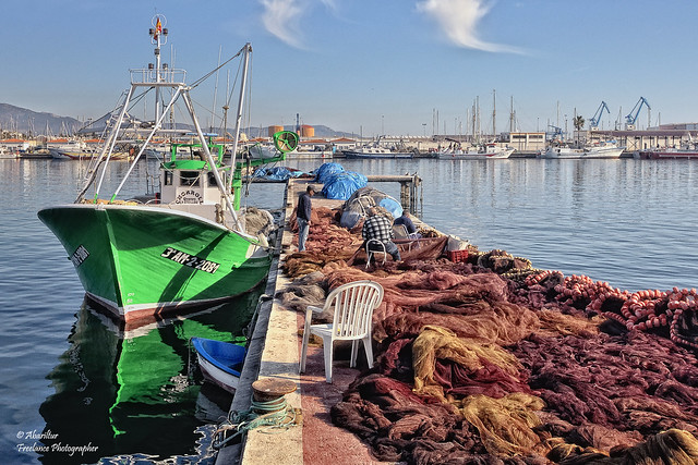 Sailors repairing fishing nets. Grau de Castelló