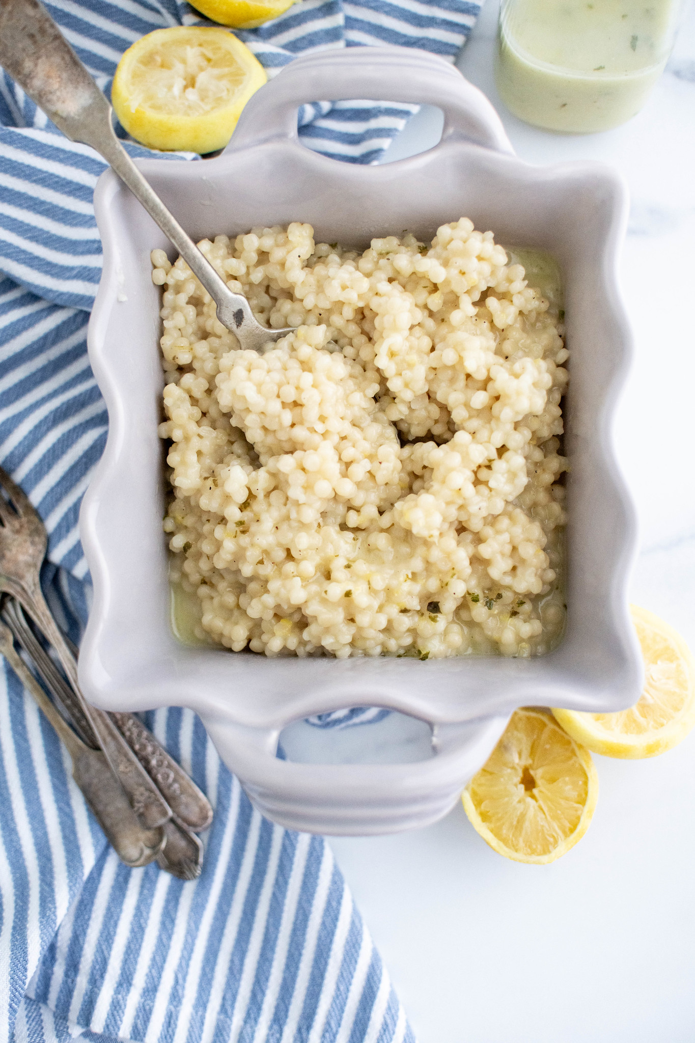 Straight down photo of lemon couscous with a spoon in the dish.