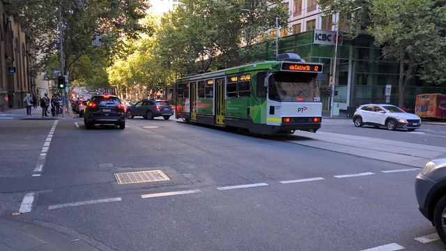 A class tram #237 running a Route 12 service to Victoria Gardens blocked by a car on Collins Street at the intersection with Queen Street, Melbourne