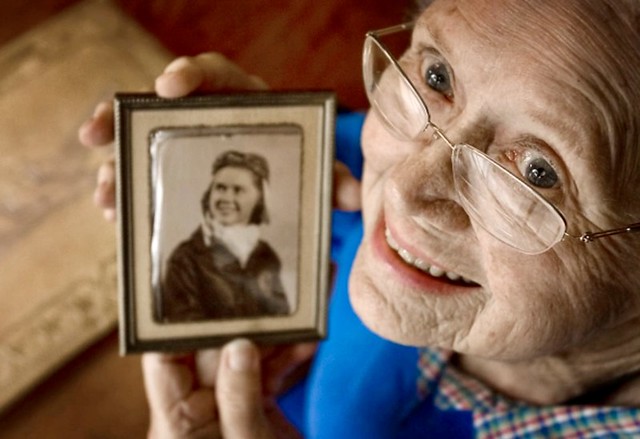 In this June 19, 2009 photo Susie Bain poses in Austin, Texas, with a 1943 photo of herself when she was one of the Women Airforce Service Pilots (WASPs) during World War II.