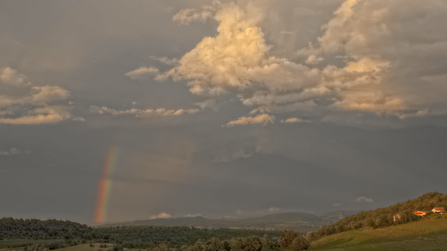 Rainbow, crepuscular rays, and clouds