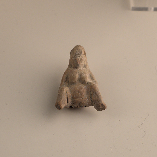 A third Tarentine miniature terracotta pendant in the form of a woman giving birth