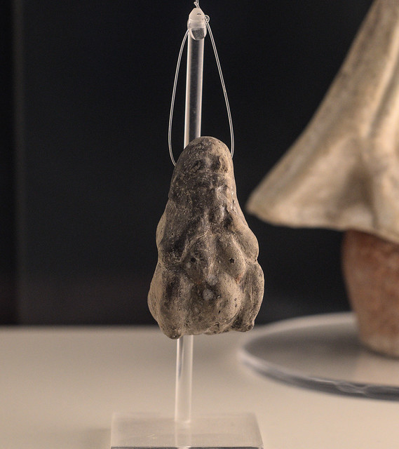 Tarentine miniature terracotta pendant in the form of a woman giving birth