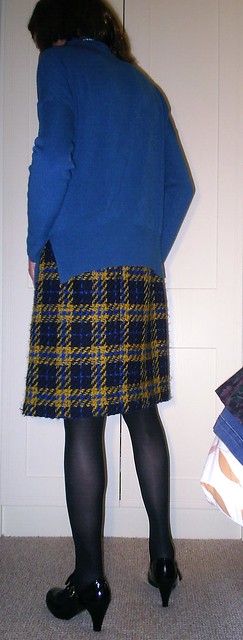Blue jumper with blue and yellow tartan skirt