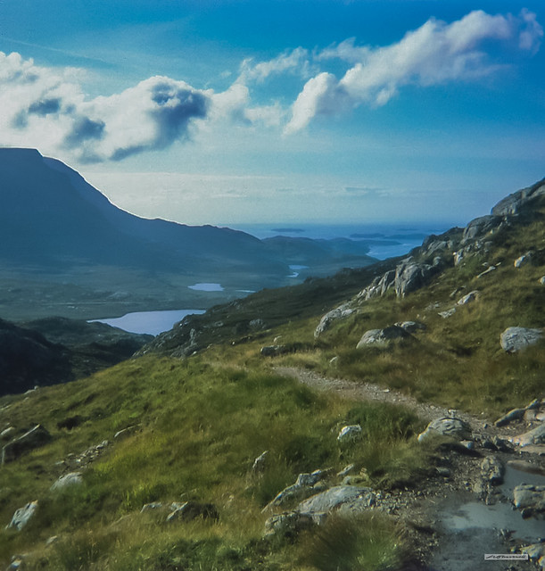 Looking past the peaks of Quinag to Loch Inver, Enard Bay and its islands, Assynt, Sutherland.