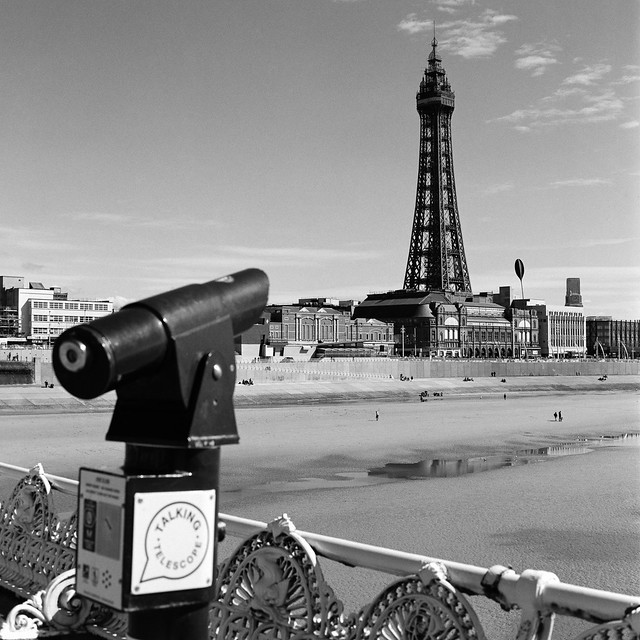 A telescope in the foreground with Blackpool Tower tyhe focus of the image