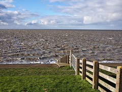 Standing on the dike at high tide with heavy wind