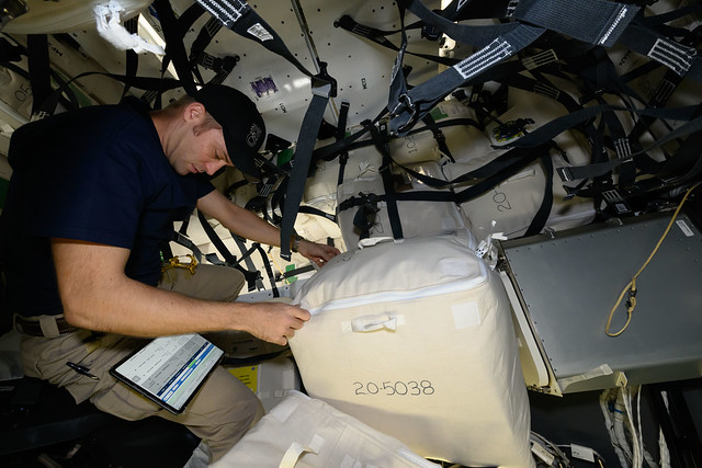 Astronaut Matthew Dominick checks cargo procedures on a computer tablet