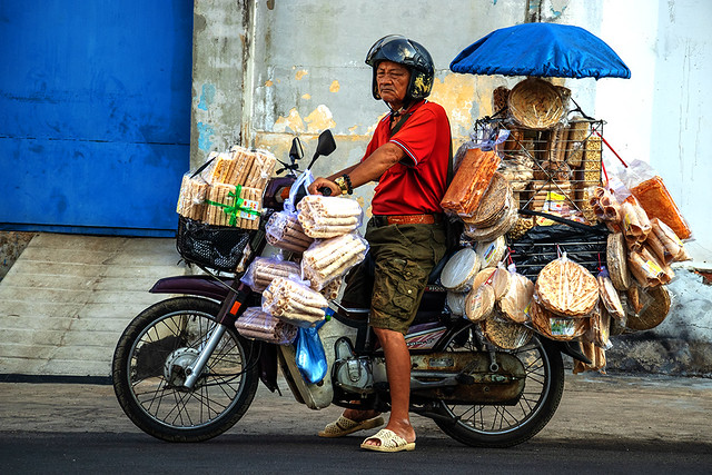 Man selling assorted wafers and sweets from his motorbike on 4-24-24--Vung Tau copy