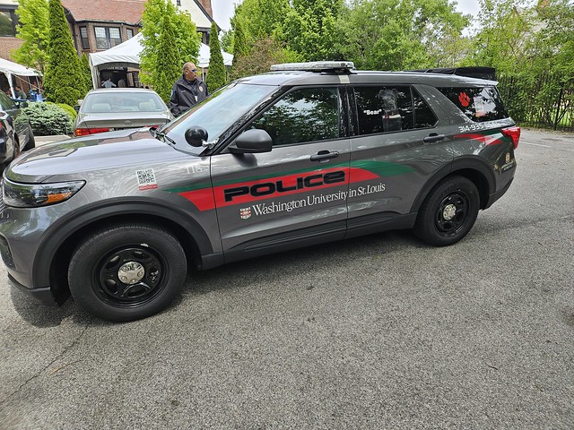 Washington University Police Department  Ford Explorer Police Interceptor SUV Comfort dog unit. K9s Bear and Brookie are transported in the same vehicle. Their images are each on a side of the SUV.