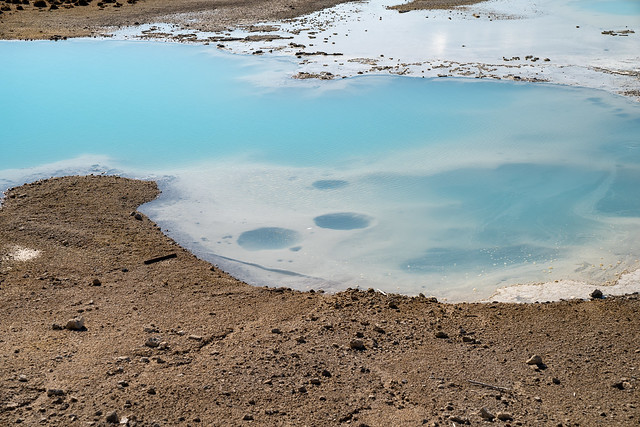 Beautiful milky teal water in a hot spring along the porcelain basin trail, in Yellowstone National Park - Norris Geyser Basin area
