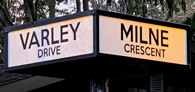 Illuminated white/yellow street signs, corner of Varley and Milne