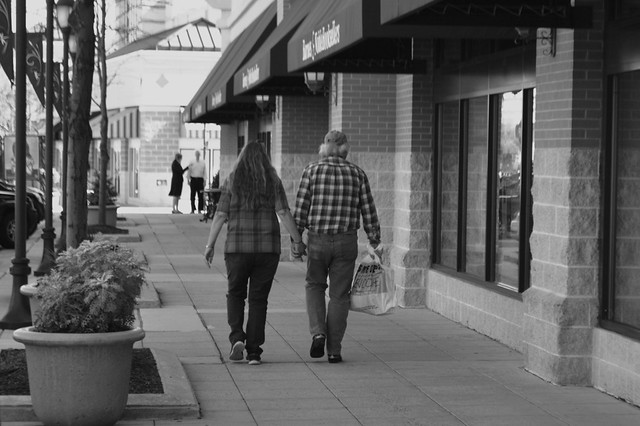 Hand in hand walking in the shopping center