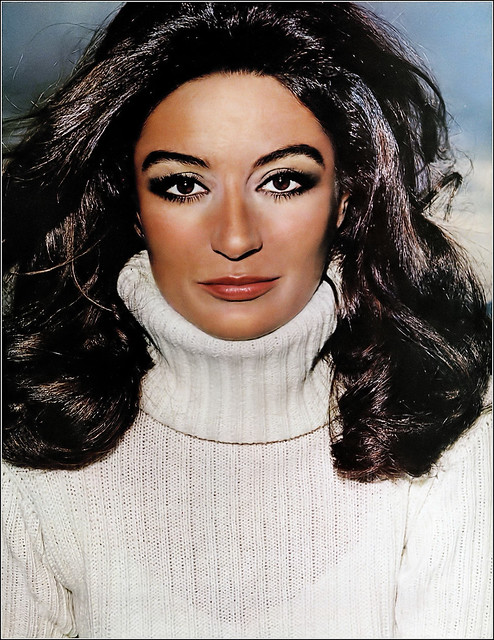 Anouk Aimée is wearing a sleek white wool sweater that triple-folds into a columnar turtleneck and belted low by Geist & Geist, photo by Hiro, Harper's Bazaar, April 1969