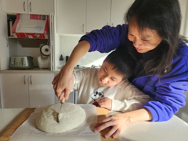 Liam learning how to slash bread dough from mummy
