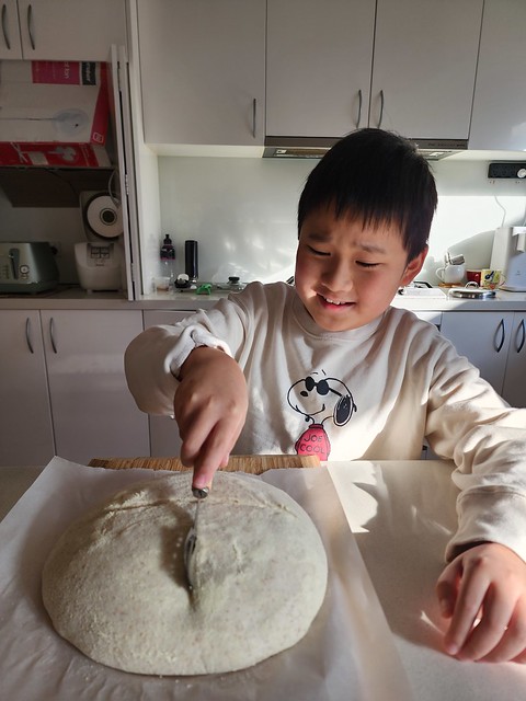 Liam slashing bread dough