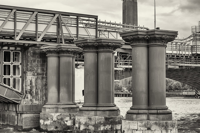 London, river Thames. Columns of the old railway bridge from 1864.
