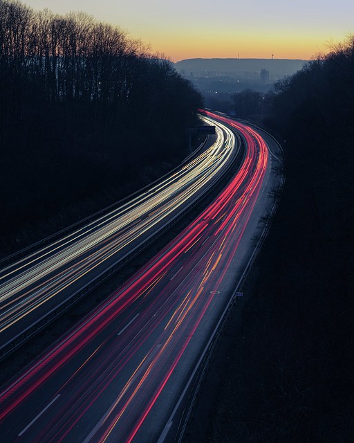 Twilight Commute: A544 Highway on The Backdrop of Aachen's Evening Glow