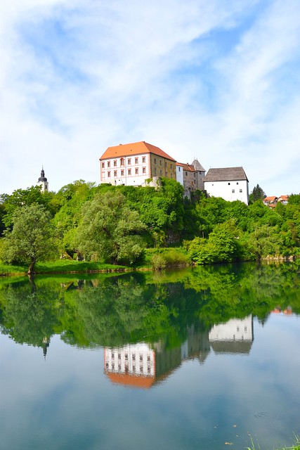 Blurry reflections of castle Ozalj in river Kupa