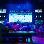 Waiting for the hockey fight A high-end honky tonk bar in a high-end downtown hotel–live country music band, shots of Tennessee whiskey, and hockey on tv. Canucks at Predator&#039;s home. All that is needed is a good fight.  
