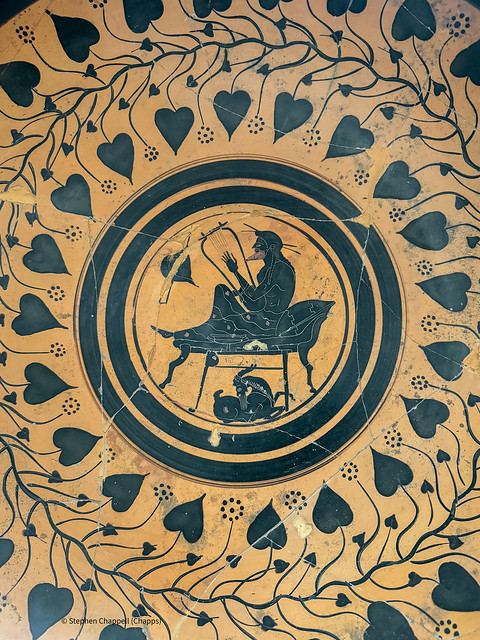 Greek black-figure kylix with a man on a kline playing a lyre