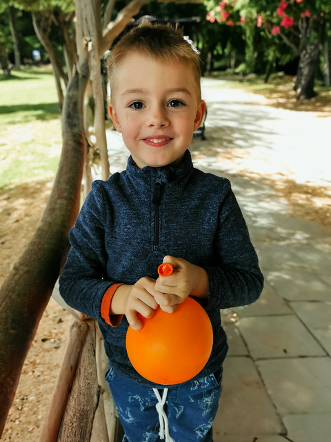 Cute boy with an orange balloon