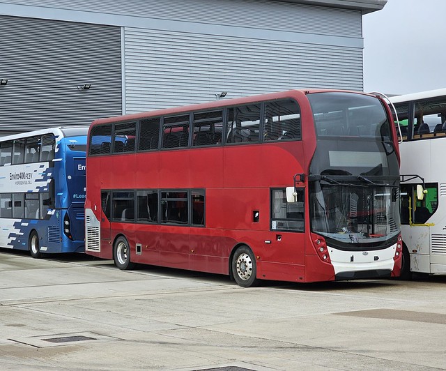 At the Alexander Dennis development site in Farnborough is this Enviro 400 MMC built as a development vehicle and appears to carries what appears to be the  crimson colours of National Express although it has nothing to do with this operator