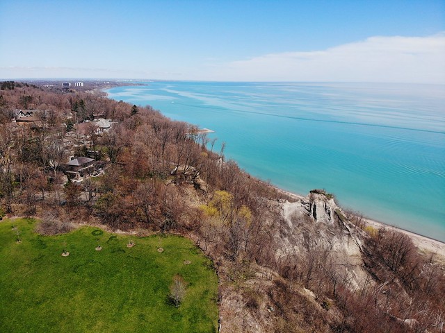 Blue sky reflecting over the calm waters of Lake Ontario at Cathedral Bluffs