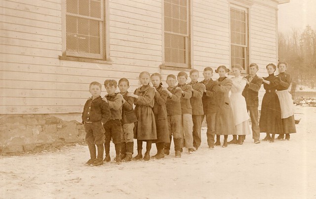 RPPC_School Class Photo_students and teacher in a line from shortest to tallest with their hands on the shoulders of the person in front of them on a snowy day