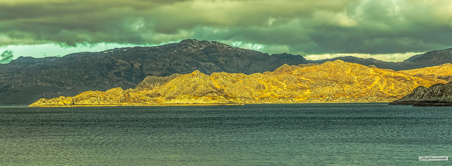 Is this a dagger which I see before me? The setting sun in the west breaks through the clouds turning the remote Ardnish Peninsula into a veritable golden dagger, across Loch Ailort, Inverness-shire, Scotland.