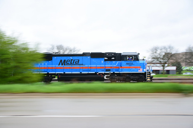 Metra's SD-70's racing along highway Big Timber in Elgin IL