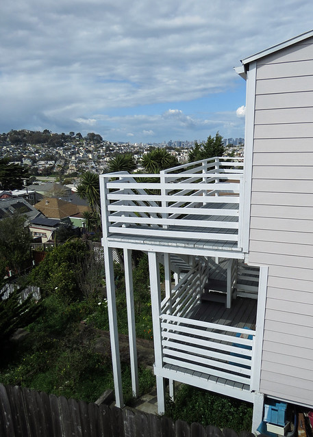 Stairs and decks seen from open house next door San Francisco in background 20240407-154201