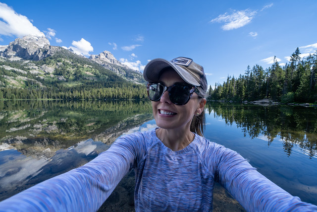 Happy hiker woman takes a selfie while at Bradley Lake in Grand Teton National Park Wyoming