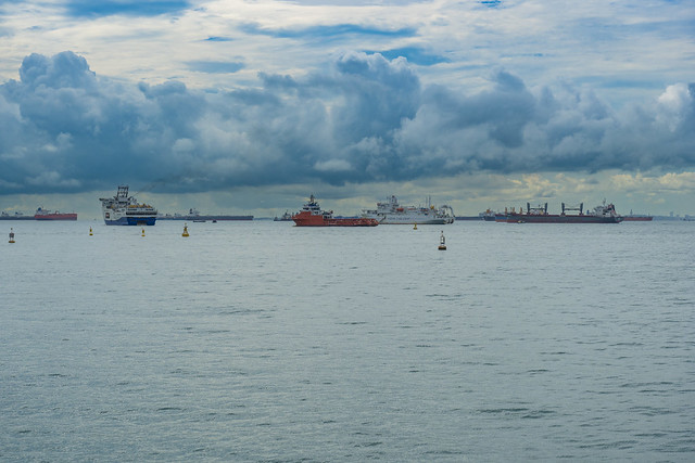 Ships in the roadstead under a cloudy sky in Singapore