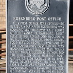 U.S. Post Office (Rosenberg, Texas) Historical maker for the U.S. Post Office in Rosenberg, Texas.  The plaque reads:

Rosenberg Post Office - This post office was established in 1881, a year after Rosenberg was founded on the newly laid route of the Santa Fe Railroad. Early post office locations include a hotel and a general store. Parcel Post service began in 1913, and by 1928 Rosenberg&#039;s Post Office was handling mail from 24 mail trains per day. The U. S. Congress authorized the building of a district post office at 2103 Avenue G in 1939. Home delivery began in 1948. The 1939 structure was expanded and modernized in 1966-67. The history of postal service in Rosenberg reflects the growth and development of the community.