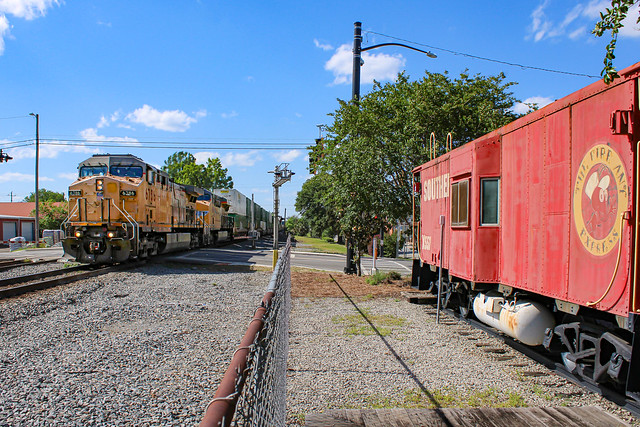 UP 6786 leads NS 249 by Southern X557 in Adel, GA.