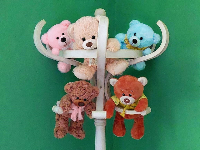 Teddy bears on coat rack