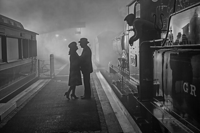 Lovers say a fond farewell on a Great Western station platform as the driver of Churchward City Class 4-4-0 no.3717 