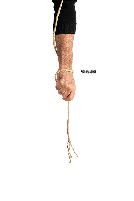Man holding breaking rope on a white background