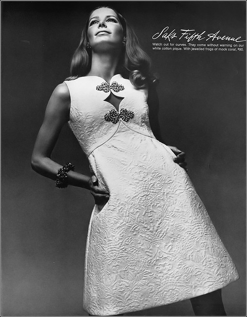 Vicki Hilbert in lovely dress of white cotton piqué with jeweled forgs of mock coral at Saks Fifth Avenue, Harper's Bazaar, May 1969