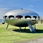 Futuro House, Veterans Memorial Drive and Livingston Avenue, Livingston, IL Manufactured sometime between 1968 and 1974 by the Futuro Corporation of Philadelphia, this Modern Futurist building is one of several Futuro houses that exist across the world, manufactured according to the design of Finnish architect Matti Suuronen.  The building, which exists as a shell with no interior, features a fiberglass shell with elliptical window openings, a steel-frame floor structure, steel support legs, and a fold-down stairway that is fixed in the open position.  Unlike many other surviving Futuro houses, this one is just a hollow shell, and has been altered with the addition of a silver paint job, covering the previous green exterior color, and has had the remainder of its windows removed.  The house is a distinctive sight along Interstate 55, and is a reminder of the optimistic and experimental architecture that evolved in the mid-20th Century.