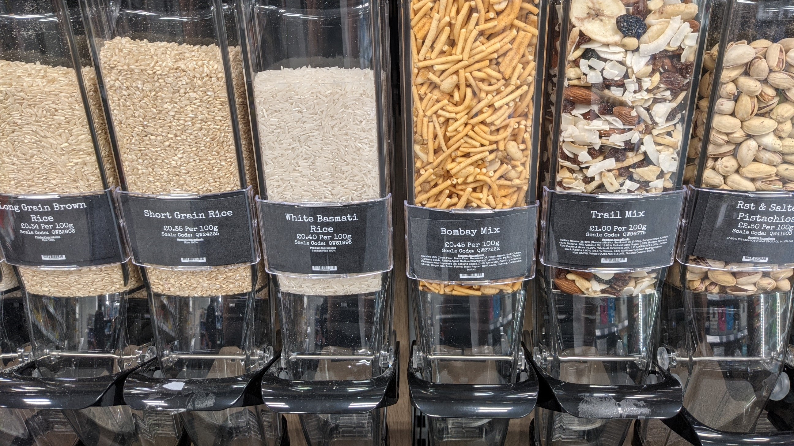 A row of refillable dispensers with food 