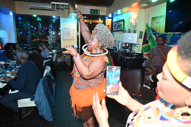 DSC_5043 South African Freedom Day Celebration at Wazobia Nigerian Restaurant Old Kent Road London 27th April 2024 with Busi Mhlanga Cultural Singer in Orange and Leopard Skin Print Outfit with Zulu Beads