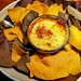 Crab queso dip with blue and yellow corn tortilla chips