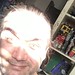 The artist with sun in his eyes makes him look like a dangerous space-lizard 48 year old nutter at home in the background Lego and art can be seen on a shelf oh yeah he/it is me taking a selfie of my graying polar bear mug ( that is MushroomBrain )