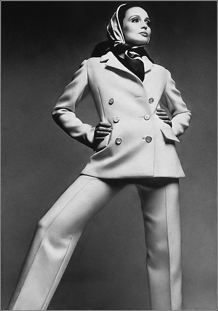 Berkley Johnson in white wool blazer-suit, jacket has notched revers and flared hem, the trousers straight and narrow, under a sleeveless blouse in navy blue jersey, by Norman Norell, photo by Francesco Scavullo, Harper's Bazaar, May 1969