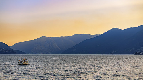 Sunset over the Lago Maggiore by Tambako the Jaguar, I took this photo from the shore of the Lago Maggiore in Ascona, Tessin, at Sunset. I liked the back