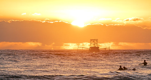 Trawling at Sunrise by Leo(Blue)Mayer, Fishing boats and surfers are enjoying a beautiful morning on the water, with a hot day on the way.s