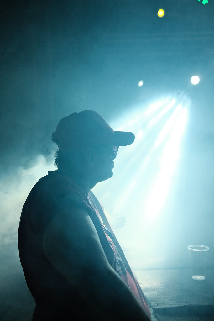 Musician performs on stage with dramatic lighting in a smo… | Flickr