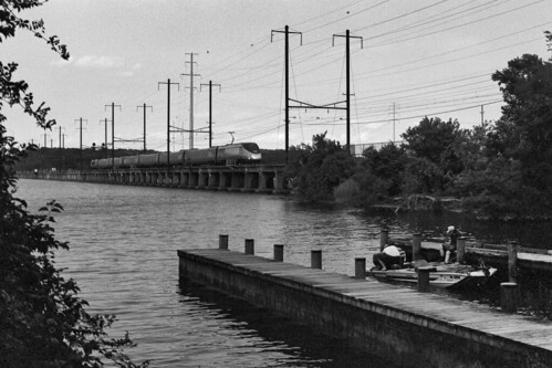 Southbound Acela at Bush by DJ Witty, Amtrak southbound Acela trainset crosses the Bush River at sunset as fishermen ready their boat for